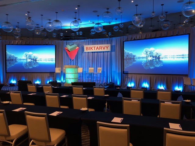 Blue-lit room with twin screens